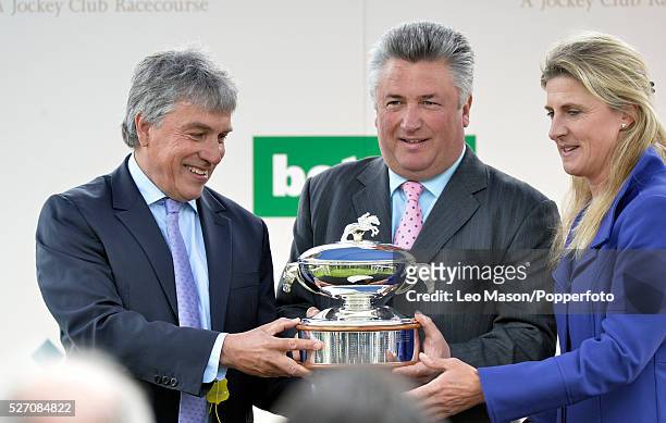 British National Hunt horse trainer Paul Nicholls, in centre, is presented with the trophy after becoming the British jump racing Champion Trainer...
