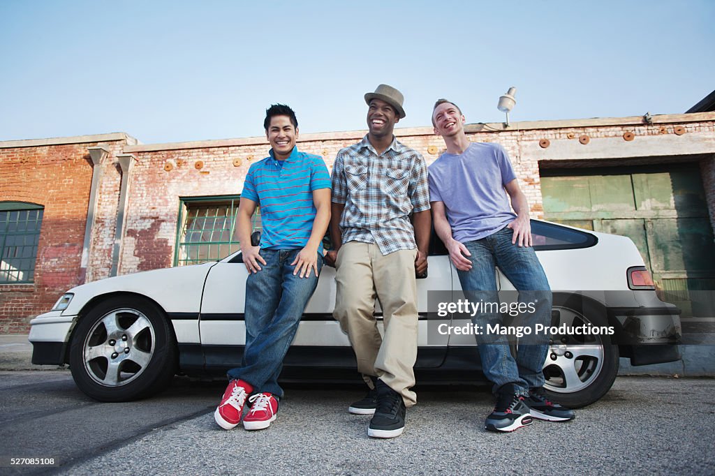 Young friends standing near car