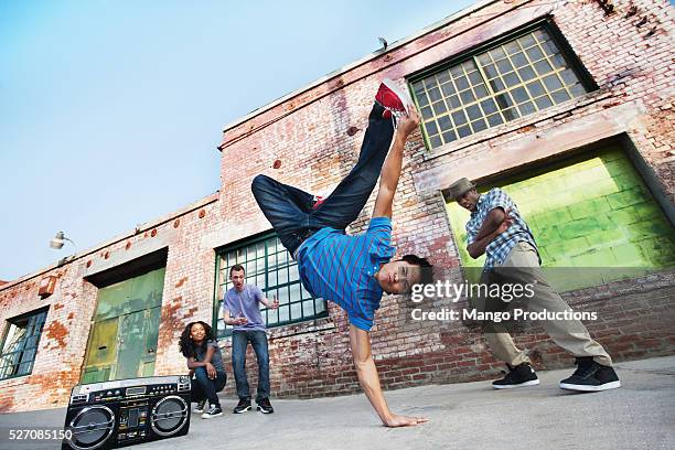 young man doing handstand - ghettoblaster stock-fotos und bilder