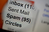 Magnifying glass showing a spam folder.