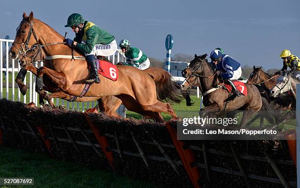 View of horses and riders competing in the William hill - Download The App Mares' Handicap Hurdle race during the William Hill Winter Festival...