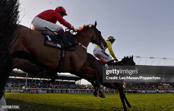 Sire De Grugy ridden by Jamie Moore clears the last fence on the 1st lap to go on to win by 4 lengths in the williamhill.com Desert Orchid Chase race...