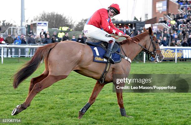 Sire De Grugy ridden by Jamie Moore clears the last fence to win by four lengths the williamhill.com Desert Orchid Chase race during the William Hill...