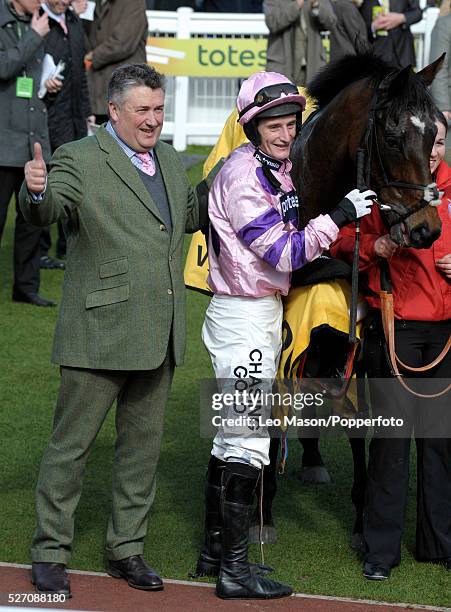 Jockey Daryl Jacob pictured with his ride Zarkandar and trainer Paul Nicholls after winning the JCB Triumph Hurdle during the Cheltenham National...