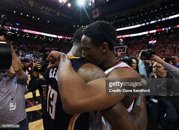 DeMar DeRozan of the Toronto Raptors and Paul George of the Indiana Pacers embrace following Game Seven of the Eastern Conference Quarterfinals...