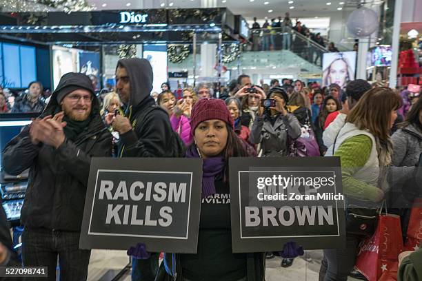 New York-USA 28 November 2014: Demonstrators hold signs Inside of Macy's protesting the St Louise Grand Jury decision not to indict officer Darren...