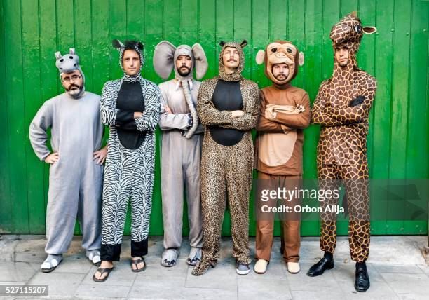group of people with animal costumes - funny monkeys stockfoto's en -beelden