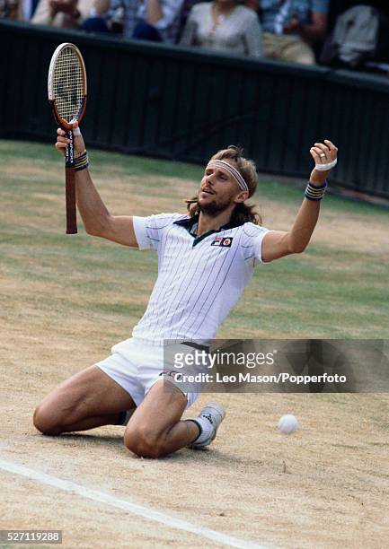 Swedish tennis player Bjorn Borg sinks to his knees and raises his arms in the air after defeating Roscoe Tanner to win the final of the Men's...