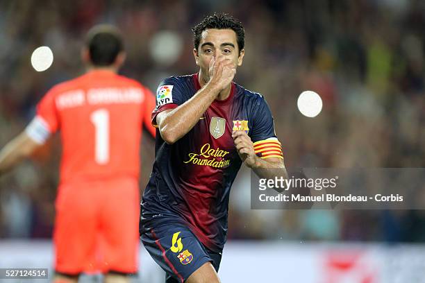 Xavi Hernandez of FC Barcelona celebrates after scoring a goal during the first leg of the Spanish Supercup football match between FC Barcelona and...