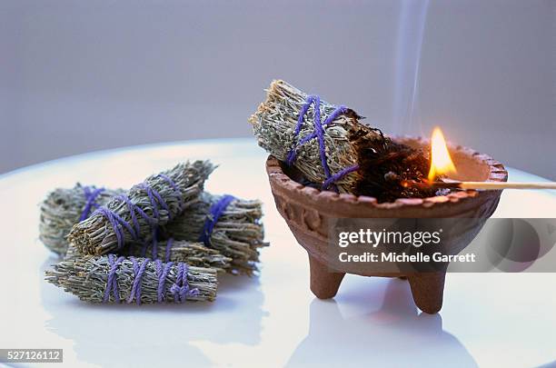 american indian herbal smudge stick burning - burning sage stock pictures, royalty-free photos & images