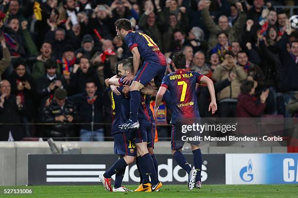 Lionel Messi of FC Barcelona celebrates with teammates after scoring his team's second goal during the UEFA Champions League round of 16 second leg...