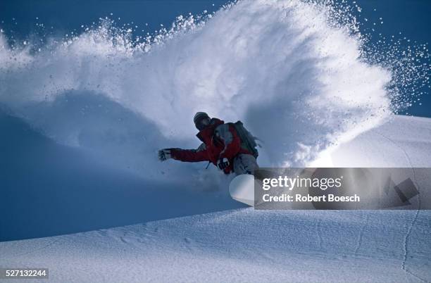 snowboarder in the deep powder snow - snowboard stock-fotos und bilder
