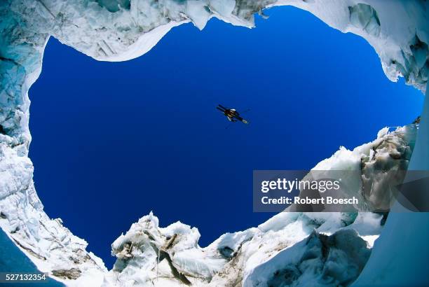 skier jumping over a crevasse - crevasse stock pictures, royalty-free photos & images