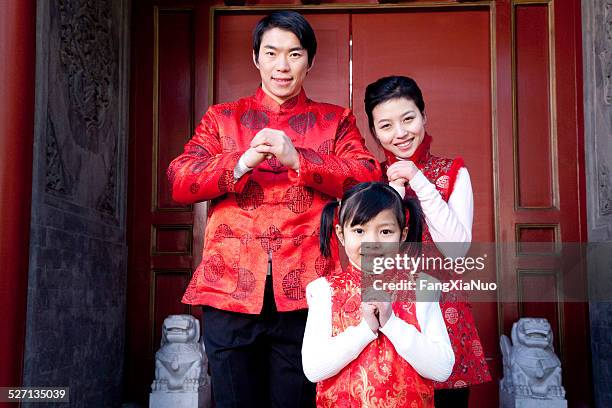 family celebrates chinese new year - the cheongsam stock pictures, royalty-free photos & images