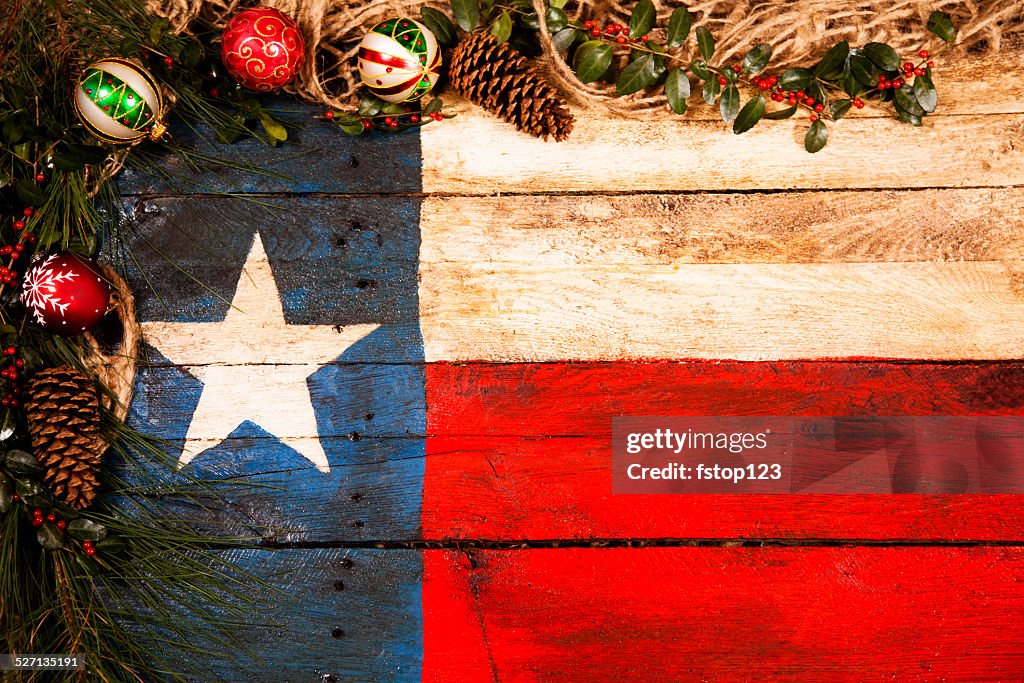 Texas flag, wooden. Christmas decorations, pine cones, ornaments, holly, garland.