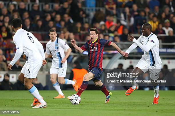 Lionel Messi of FC Barcelona duels for the ball with Yaya Toure of Manchester City FC during the UEFA Champions league Round of 16 second leg...