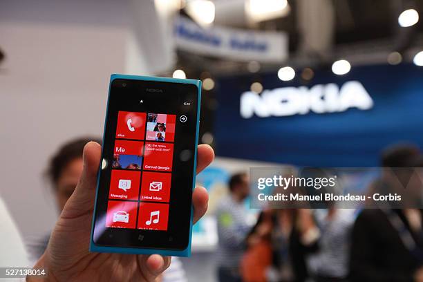 Hostess holds the Nokia Lumia 900 mobile phone at the Mobile World Congress in Barcelona on February 29, 2012 on the Third day of the Mobile World...