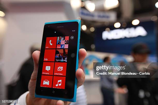 Hostess holds the Nokia Lumia 900 mobile phone at the Mobile World Congress in Barcelona on February 29, 2012 on the Third day of the Mobile World...