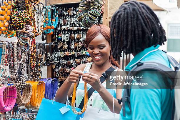 african female excited about her new necklace. - craft market stock pictures, royalty-free photos & images