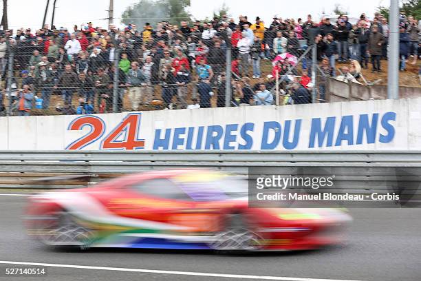 World Endurance Championship 2013 - 24h Le Mans logo is seen on a wall as a car drives during the 90th 24-hour Le Mans endurance race at the Circuit...