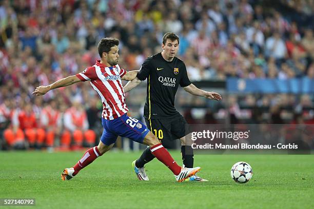 Diego Ribas of Club Atletico de Madrid duels for the ball with Lionel Messi of FC Barcelona during the UEFA Champions league Quarter Final second leg...