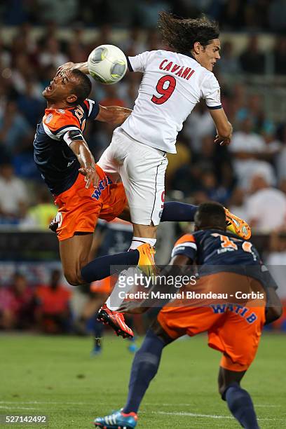 Edinson Cavani of Paris Saint Germain duels for the ball with Hilton of Montpellier HSC during the French Ligue 1 Championship football match between...