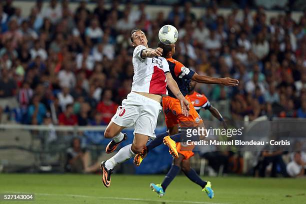 Zlatan Ibrahimovic of Paris Saint Germain duels for the ball with Hilton of Montpellier HSC during the French Ligue 1 Championship football match...