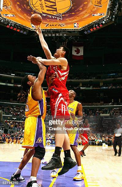 Yao Ming of the Houston Rockets shoots over Brian Grant of the Los Angeles Lakers during the game at Staples Center on April 7, 2005 in Los Angeles,...