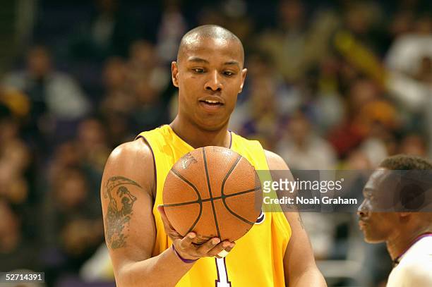 Caron Butler of the Los Angeles Lakers holds the ball during the game against the Houston Rockets at Staples Center on April 7, 2005 in Los Angeles,...