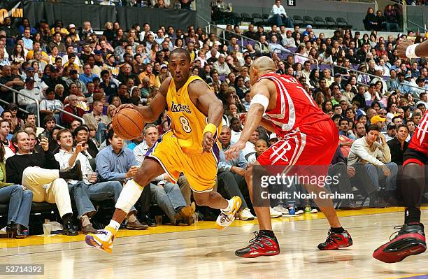 Kobe Bryant of the Los Angeles Lakers moves the ball against David Wesley of the Houston Rockets during the game at Staples Center on April 7, 2005...