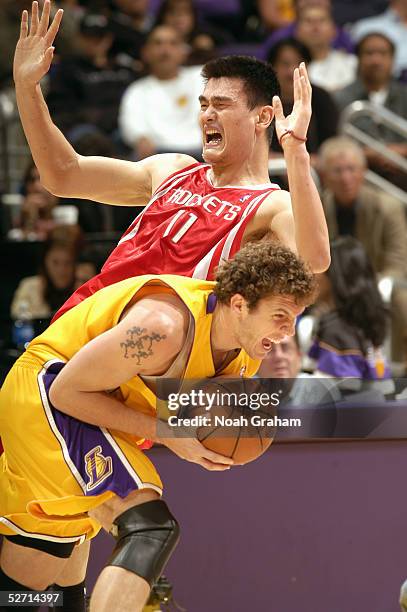 Luke Walton of the Los Angeles Lakers collides with Yao Ming of the Houston Rockets during the game at Staples Center on April 7, 2005 in Los...