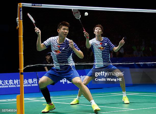 Li Junhui and Liu Yuchen of China hit a return to Lee Yong Dae and Yoo Yeon Seong of South Korea during their men's doubles final match at the 2016...