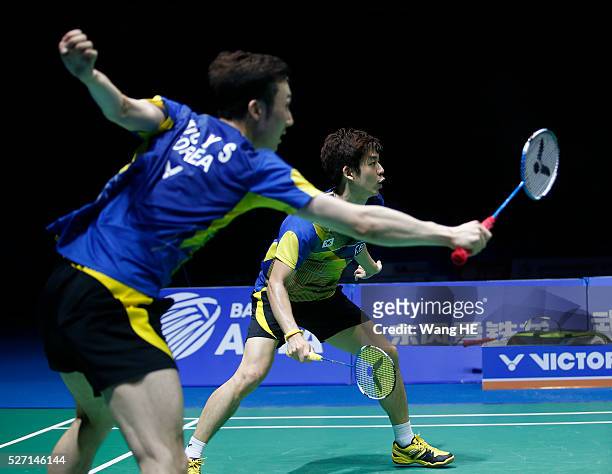 Lee Yong Dae and Yoo Yeon Seong of South Korea hit a return to Li Junhui and Liu Yuchen of China during their men's doubles final match at the 2016...