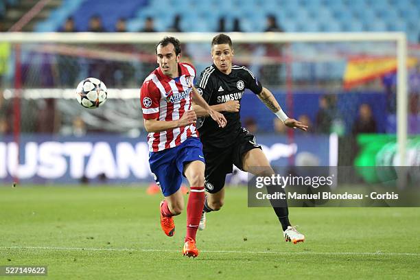 Diego Godin of Club Atletico de Madrid duels for the ball with Fernando Torres of Chelsea FC during the UEFA Champions League Semifinal first leg...