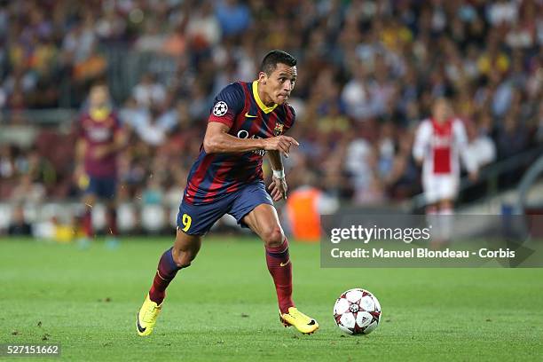 Alexis Sanchez of FC Barcelona runs with the ball during the UEFA Champions league football match between FC Barcelona and Ajax Amsterdam at the Camp...