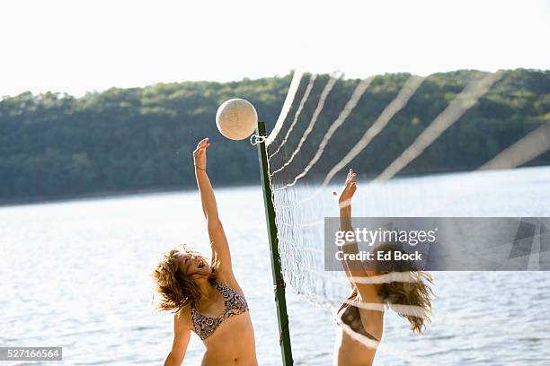 teens playing beach volleyball - girls beach volleyball stock pictures, royalty-free photos & images