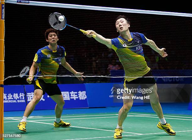 Yoo Yeon Seong and Lee Yong Dae of South Korea hit a return to Li Junhui and Liu Yuchen of China during their men's doubles final match at the 2016...
