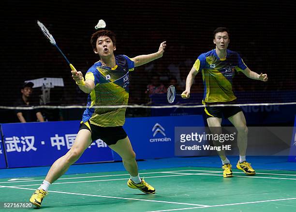 Lee Yong Dae and Yoo Yeon Seong of South Korea hit a return to Li Junhui and Liu Yuchen of China during their men's doubles final match at the 2016...