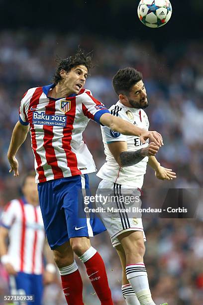 Tiago of Atletico de Madrid jumps to win a header with Isco of Real Madrid during the UEFA Champions League Quarter Final second leg match between...