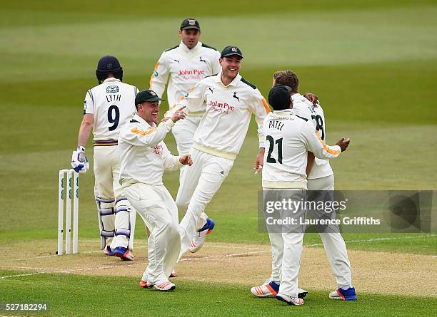 Jake Ball of Nottinghamshire is congratulated by Steven Mullaney and Stuart Broad on the wicket of Adam Lyth of Yorkshire during the Specsavers...