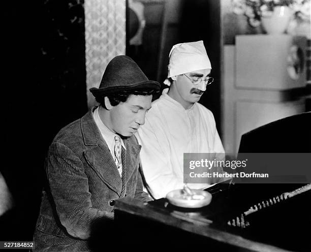 Chico and Groucho Marx play piano together in, "Duck Soup."