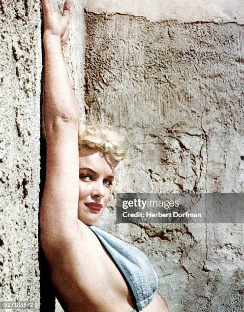 Marilyn Monroe poses in a bikini top.