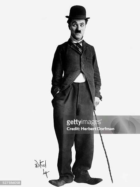 Full-length portrait of Charlie Chaplin in costume.