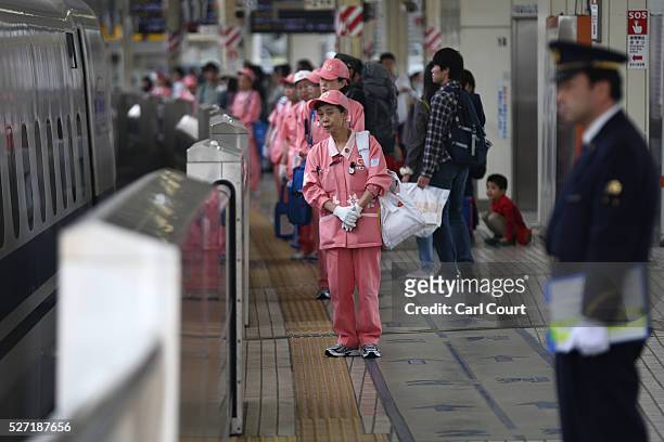 Cleaners prepare to board a Shinkansen bullet train at Tokyo Train Station on May 02, 2016 in Tokyo, Japan. The Shinkansen is a network of high-speed...