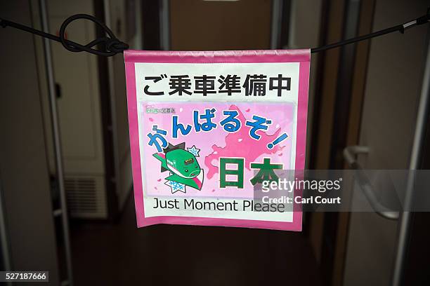 Cleaning sign is hung over the door of a Shinkansen bullet train at Tokyo Train Station on May 02, 2016 in Tokyo, Japan. The Shinkansen is a network...