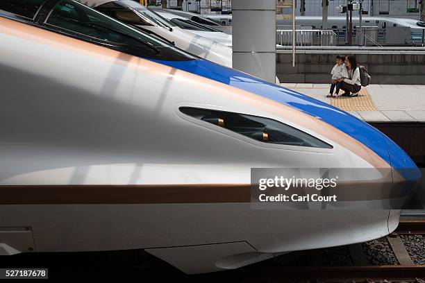 Shinkansen bullet trains are stopped at Tokyo Train Station on May 02, 2016 in Tokyo, Japan. The Shinkansen is a network of high-speed railway lines...