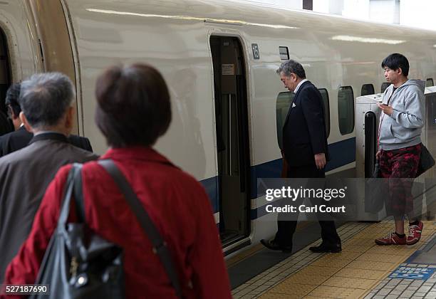 Passengers board a Shinkansen bullet train at Tokyo Train Station on May 02, 2016 in Tokyo, Japan. The Shinkansen is a network of high-speed railway...