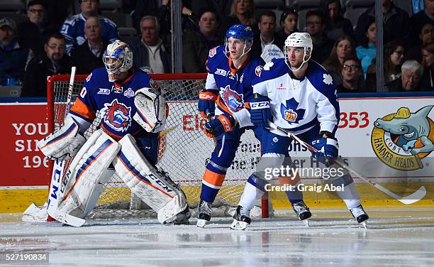 Brennan of the Toronto Marlies battles for crease space with Kevin Czuczman and Christopher Gibson of the Bridgeport Sound Tigers during AHL playoff...