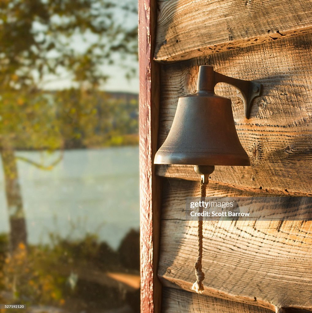 Dinner bell on wall of summer cottage