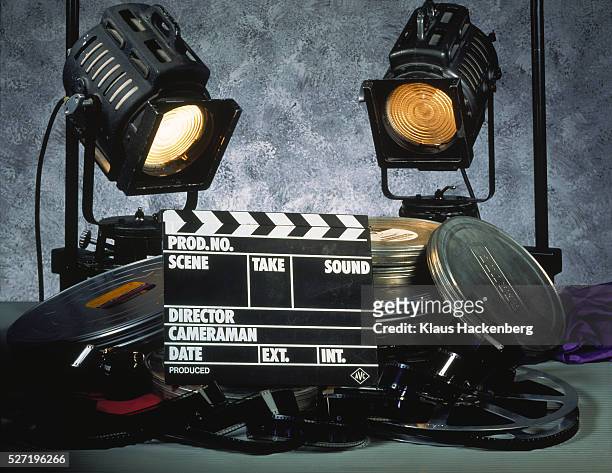 clapperboard, film and two floodlights - film reel stock-fotos und bilder